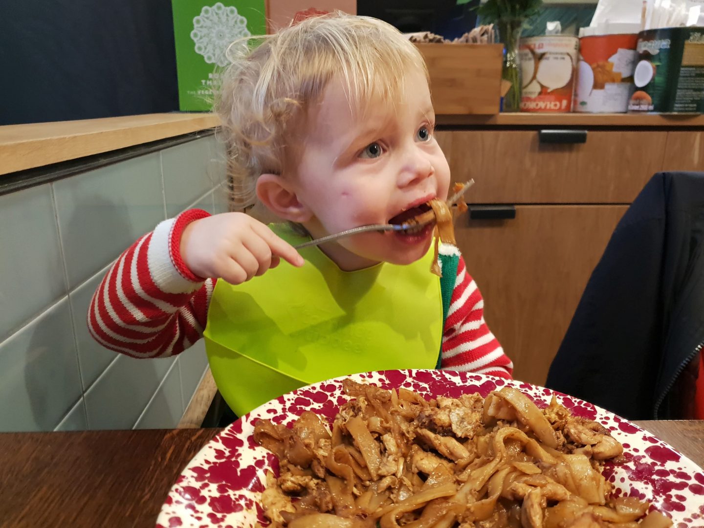 Toddler eating stir fried flat noodles at Rosa's Thai Cafe, Bluewater