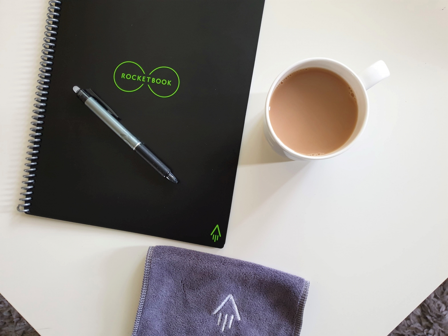 Rocketbook Everlast reusable notebook with cloth, Pilot Frixion pen and cup of tea