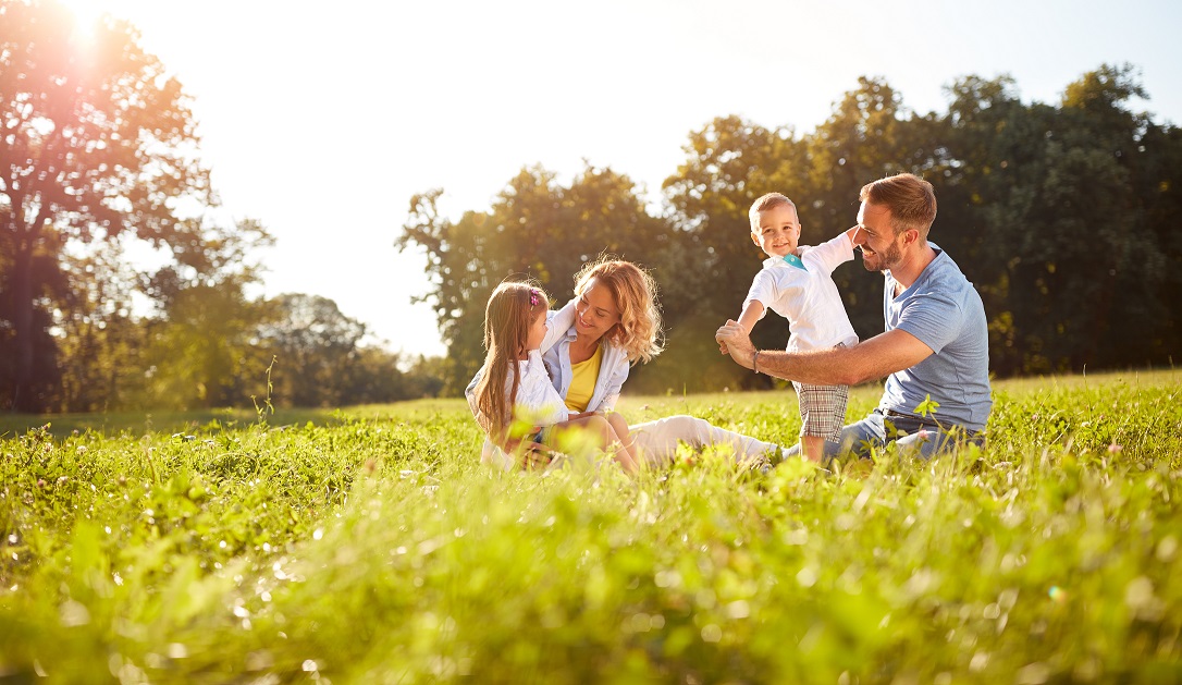 Family playing in the grass enjoying nature - asthma and hay fever