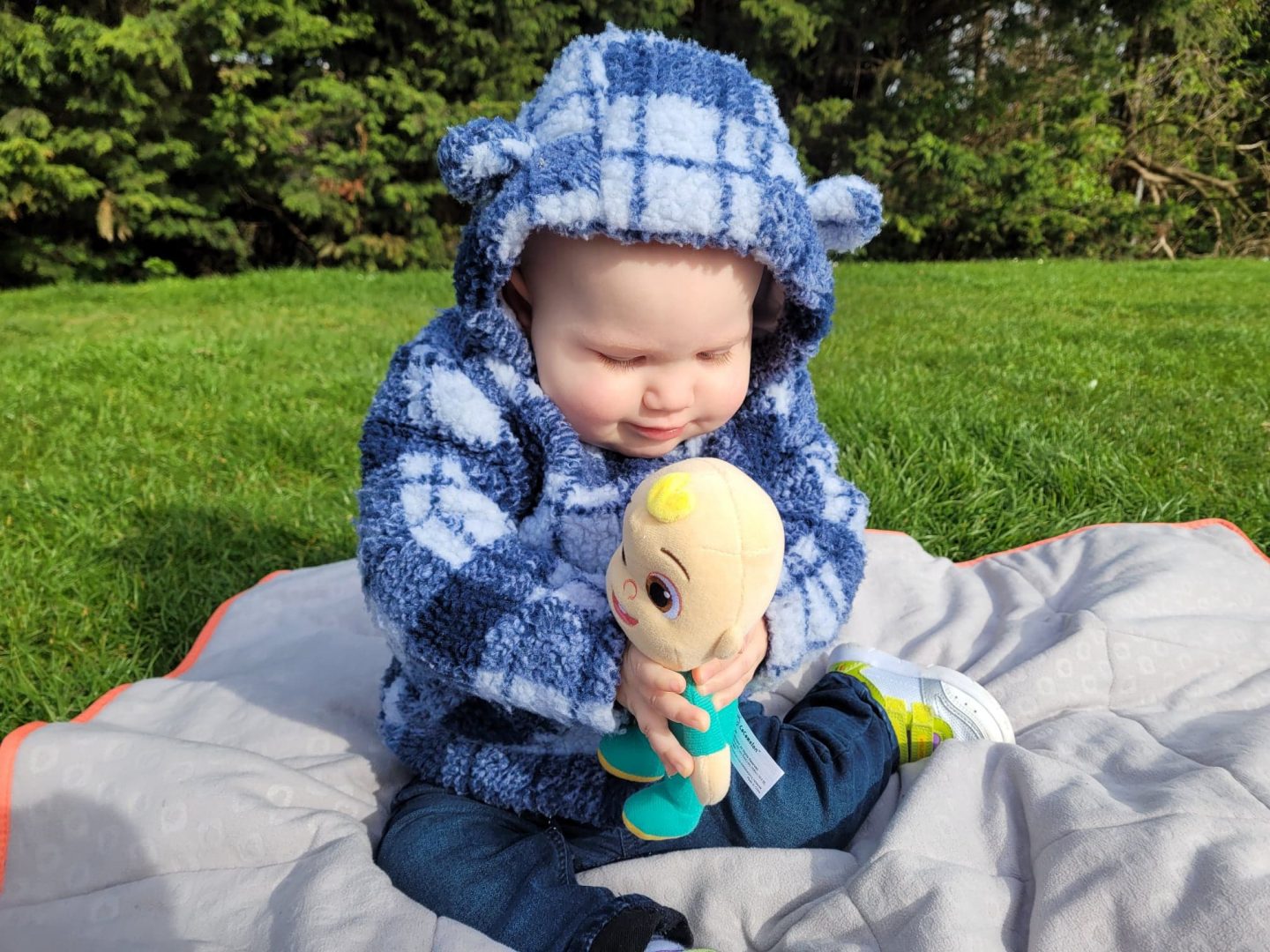 Baby playing with CoComelon Eco Plush