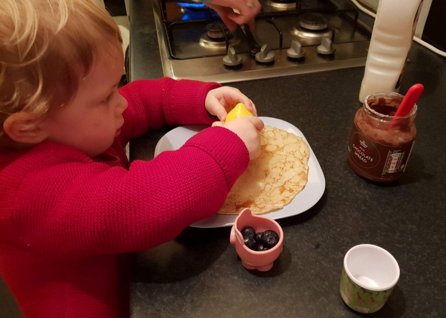 Toddler making pancakes